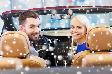 Image showing happy couple sitting in car at auto show or salon