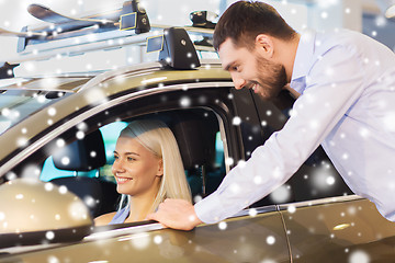 Image showing happy couple buying car in auto show or salon