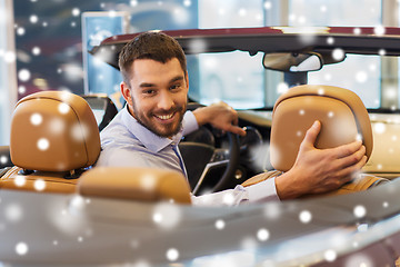 Image showing man sitting in cabriolet car at auto show or salon