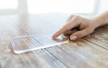 Image showing close up of woman with transparent smartphone