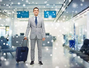 Image showing happy businessman in suit with travel bag