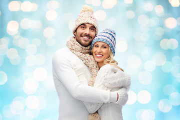 Image showing smiling couple in winter clothes hugging