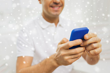 Image showing close up of happy man with smartphone at home