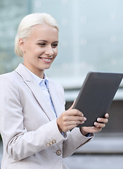 Image showing smiling businesswoman with tablet pc outdoors