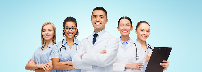 Image showing group of smiling doctors with clipboard