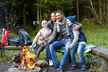 Image showing family with smartphone taking selfie near campfire