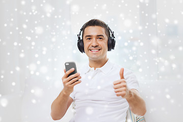 Image showing happy man with smartphone and headphones