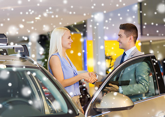 Image showing happy woman with car dealer in auto show or salon