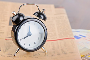 Image showing Close-up of clock, Euro banknotes and newspaper