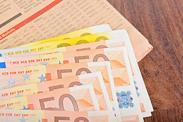 Image showing Close-up of Euro banknotes with newspaper