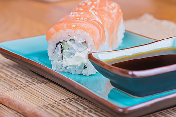 Image showing California maki sushi with fish and soy sauce