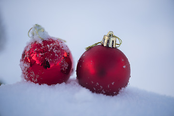 Image showing red christmas balls in fresh snow