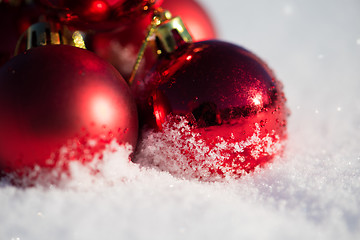 Image showing red christmas ball in fresh snow