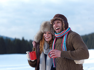 Image showing happy young couple drink warm tea at winter