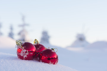 Image showing red christmas ball in fresh snow