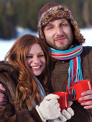 Image showing happy young couple drink warm tea at winter