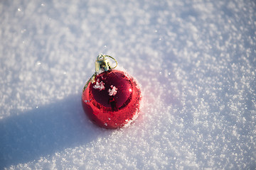 Image showing red christmas ball in fresh snow