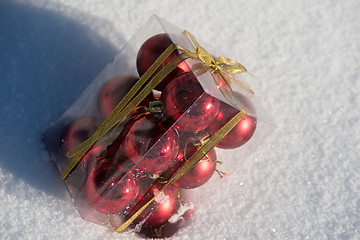 Image showing christmas ball in box on fresh  snow