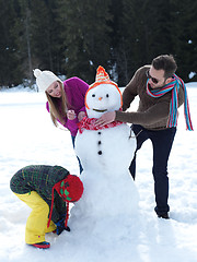 Image showing happy family making snowman