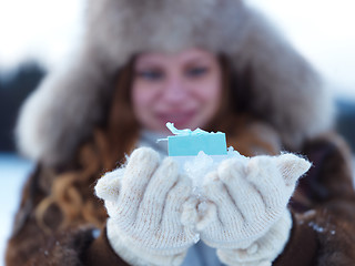 Image showing portrait of  girl with gift at winter scene and snow in backgron