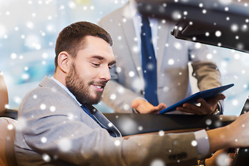 Image showing happy man with car dealer in auto show or salon