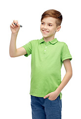 Image showing happy boy in green t-shirt with marker writing