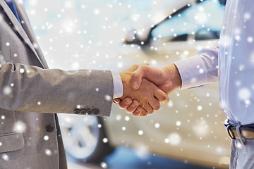 Image showing close up of male handshake in auto show or salon