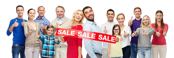 Image showing happy people with red sale sign showing thumbs up