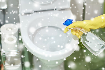 Image showing close up of hand with detergent cleaning toilet