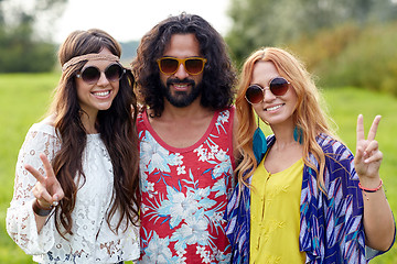 Image showing happy young hippie friends showing peace outdoors