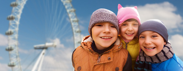 Image showing happy little children faces over ferry wheel