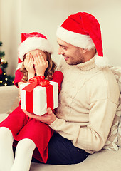 Image showing smiling daughter waiting for a present from father