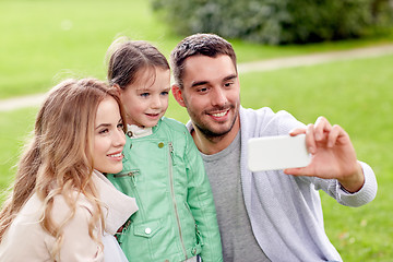 Image showing happy family taking selfie by smartphone outdoors