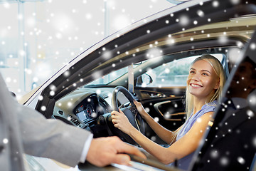 Image showing happy woman with car dealer in auto show or salon