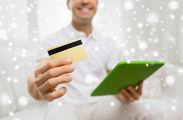 Image showing close up of man with credit card and tablet pc