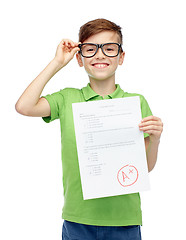 Image showing happy boy in eyeglasses holding school test result