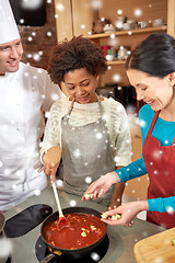 Image showing happy women and chef cook cooking in kitchen