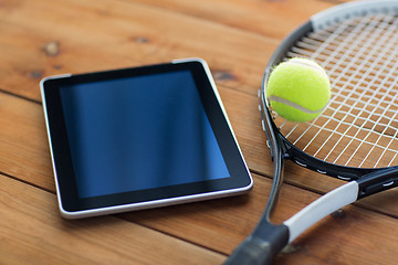 Image showing close up of tennis racket with ball and tablet pc