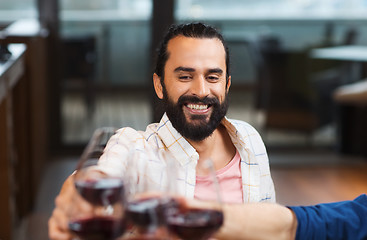 Image showing happy man clinking glass of wine at restaurant