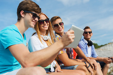 Image showing group of smiling friends with tablet pc outdoors