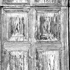 Image showing grain texture of a brown antique wooden old door in italy   euro