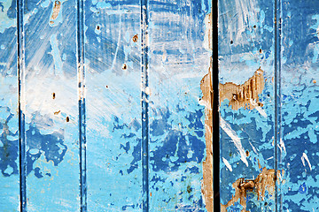 Image showing stripped  in the blue   door and rusty nail