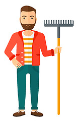 Image showing Man standing with rake.