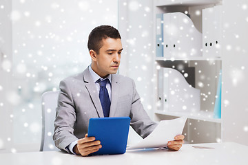 Image showing businessman with tablet pc and papers in office