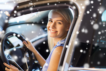 Image showing happy woman inside car in auto show or salon