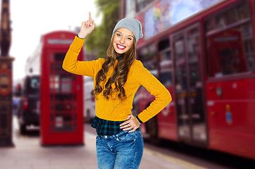 Image showing happy young woman or teen girl pointing finger up