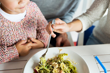 Image showing close up of family having dinner at restaurant