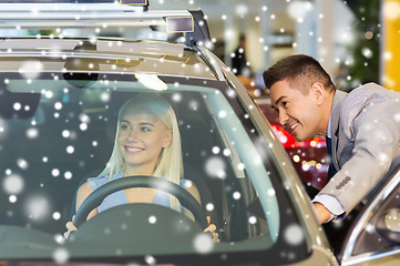 Image showing happy woman with car dealer in auto show or salon