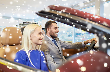 Image showing happy couple sitting in car at auto show or salon