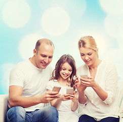 Image showing happy family with smartphones